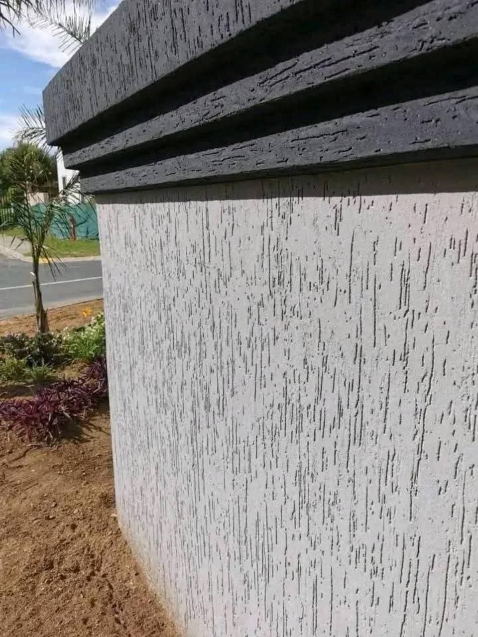 Close view of a grey Gamazine textured exterior wall finish